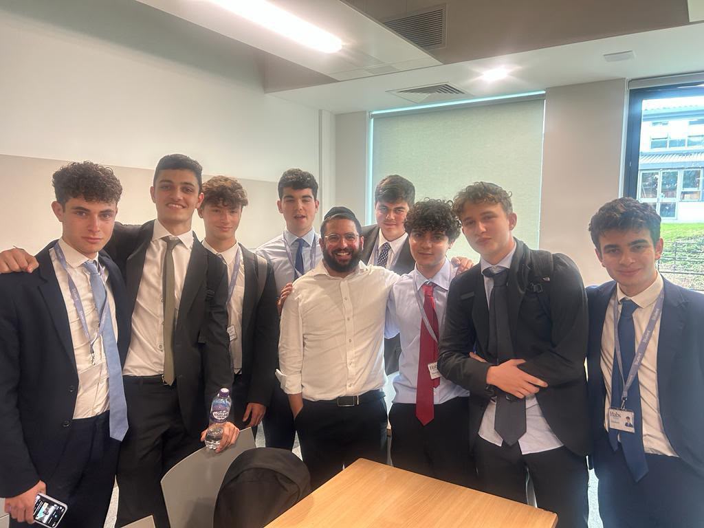 Rabbi Aidyn with a group of students in a classroom